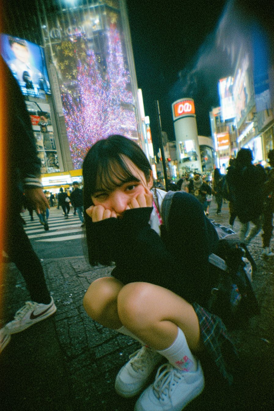 A beautiful Japanese schoolgirl photographed at Shibuya Scramble Crossing at night