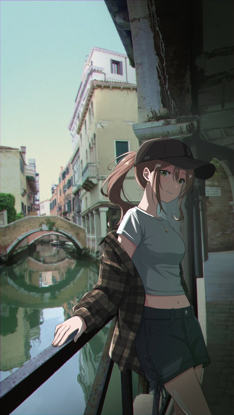 A girl is leaning on the railing and looking back in a sunny European water town
