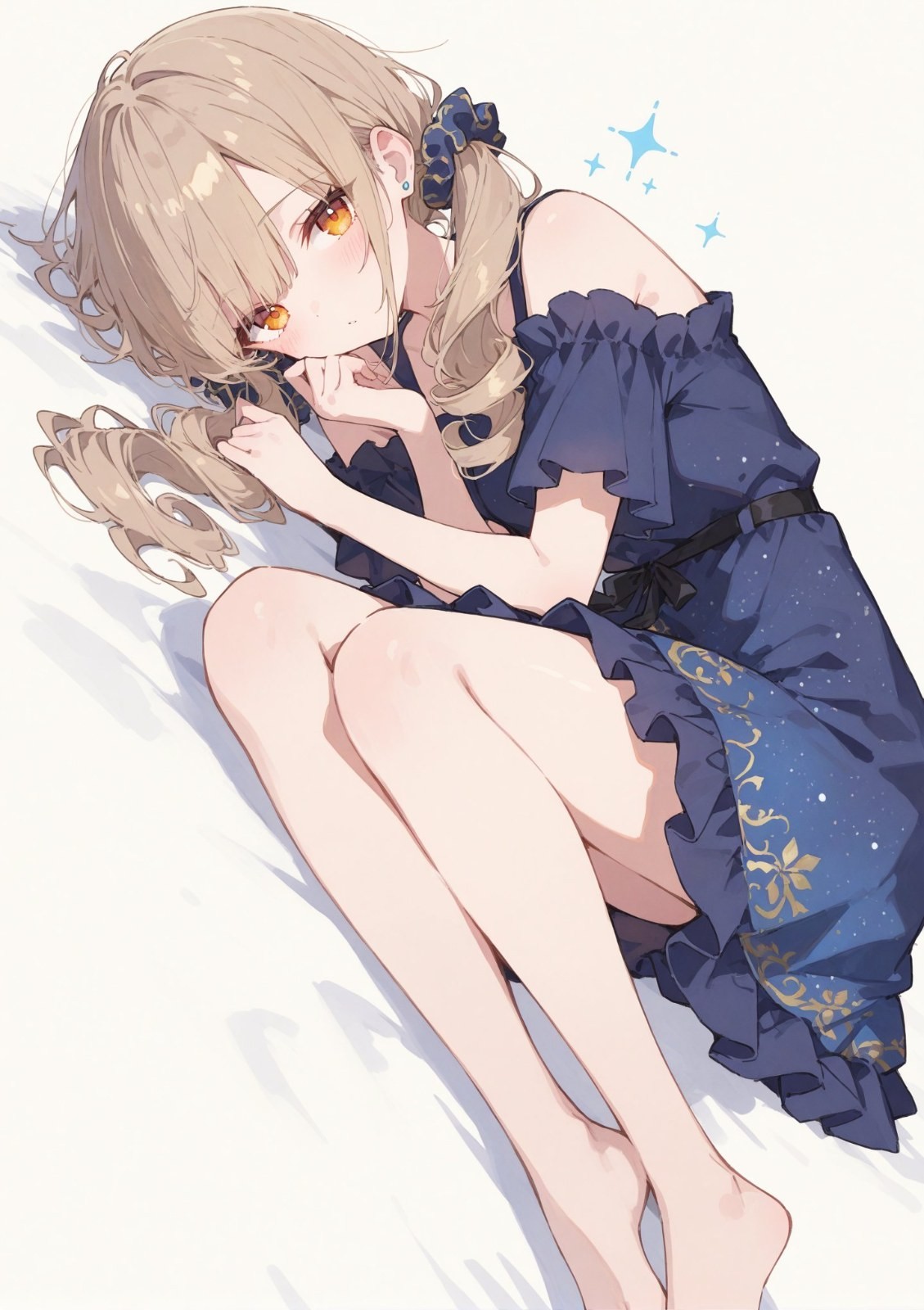 A girl lies sideways against a white background wearing a deep blue off-shoulder dress