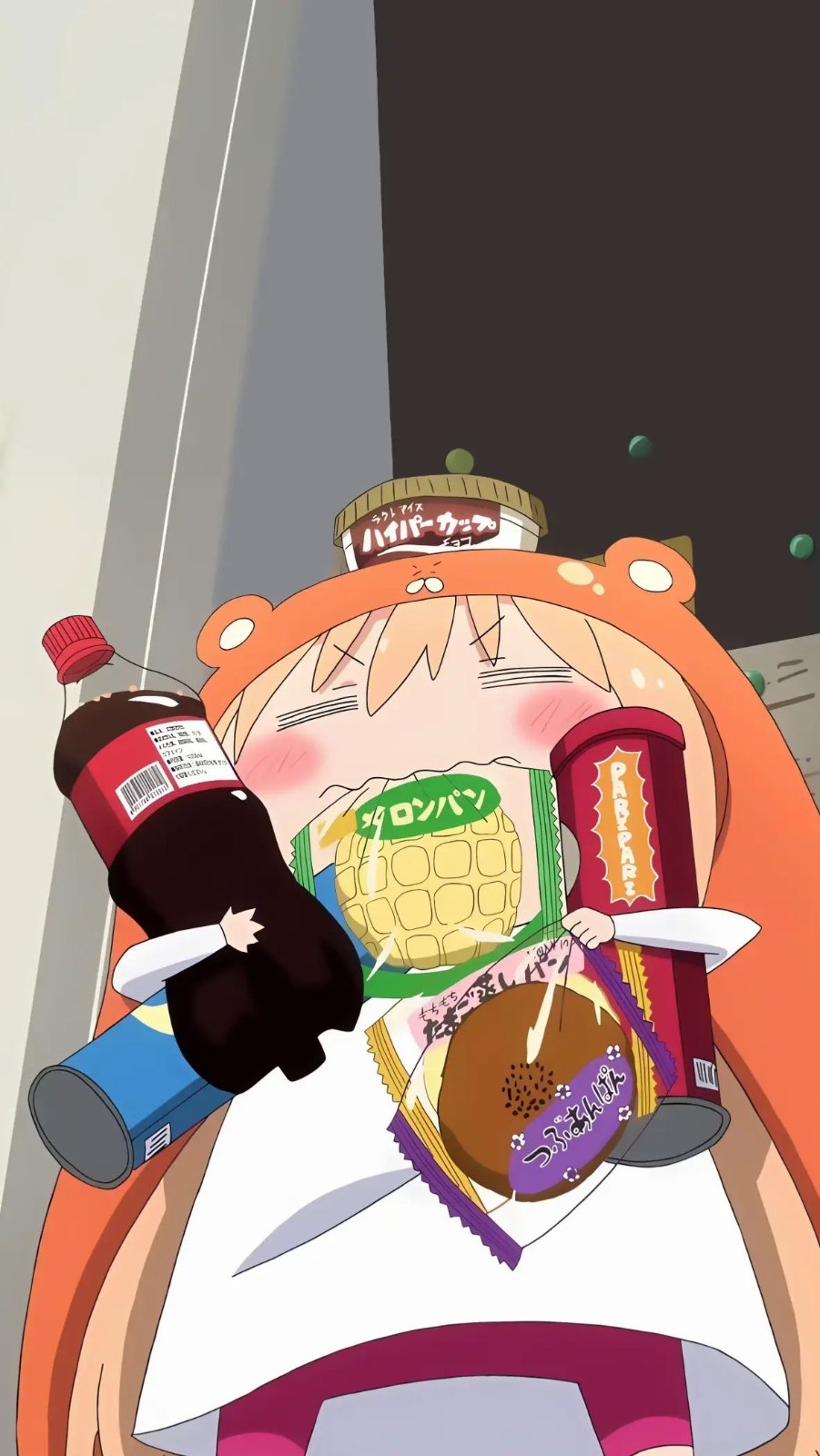 A blonde girl lies on her back indoors, embracing snacks with a satisfied smile